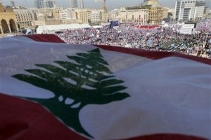 Mideast Lebanon Hariri A huge Lebanese flag is seen as people from across the country take part in a rally in Beirut's Martyrs' Square, Lebanon, Sunday, Feb. 14, 2010