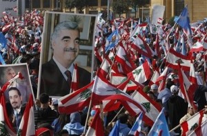 Mideast Lebanon Hariri Lebanese people carry national flags and pictures of Lebanese Prime Minister Saad Hariri, left, and his father slain former Prime Minister Rafik Hariri, right, during the rally