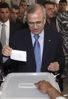 ELECTIONS MUNICIPAL suleiman w ballot Lebanon's President Michel Suleiman casts his vote during the country's municipal elections at a polling station in his hometown of Amchit